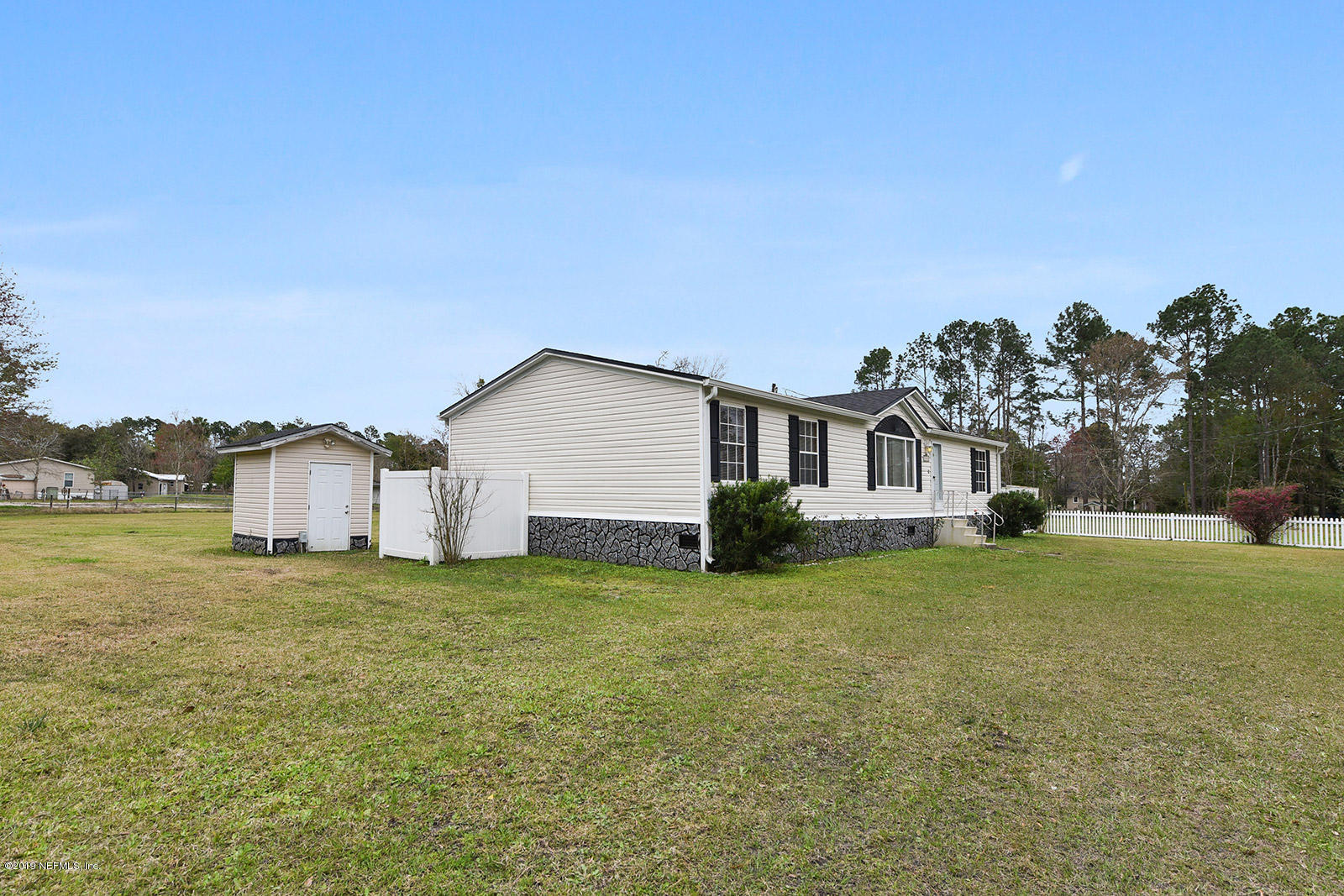 75302 Edwards Road Yulee, FL 32097 - Photo 4 of 25 a view of a house with a yard
