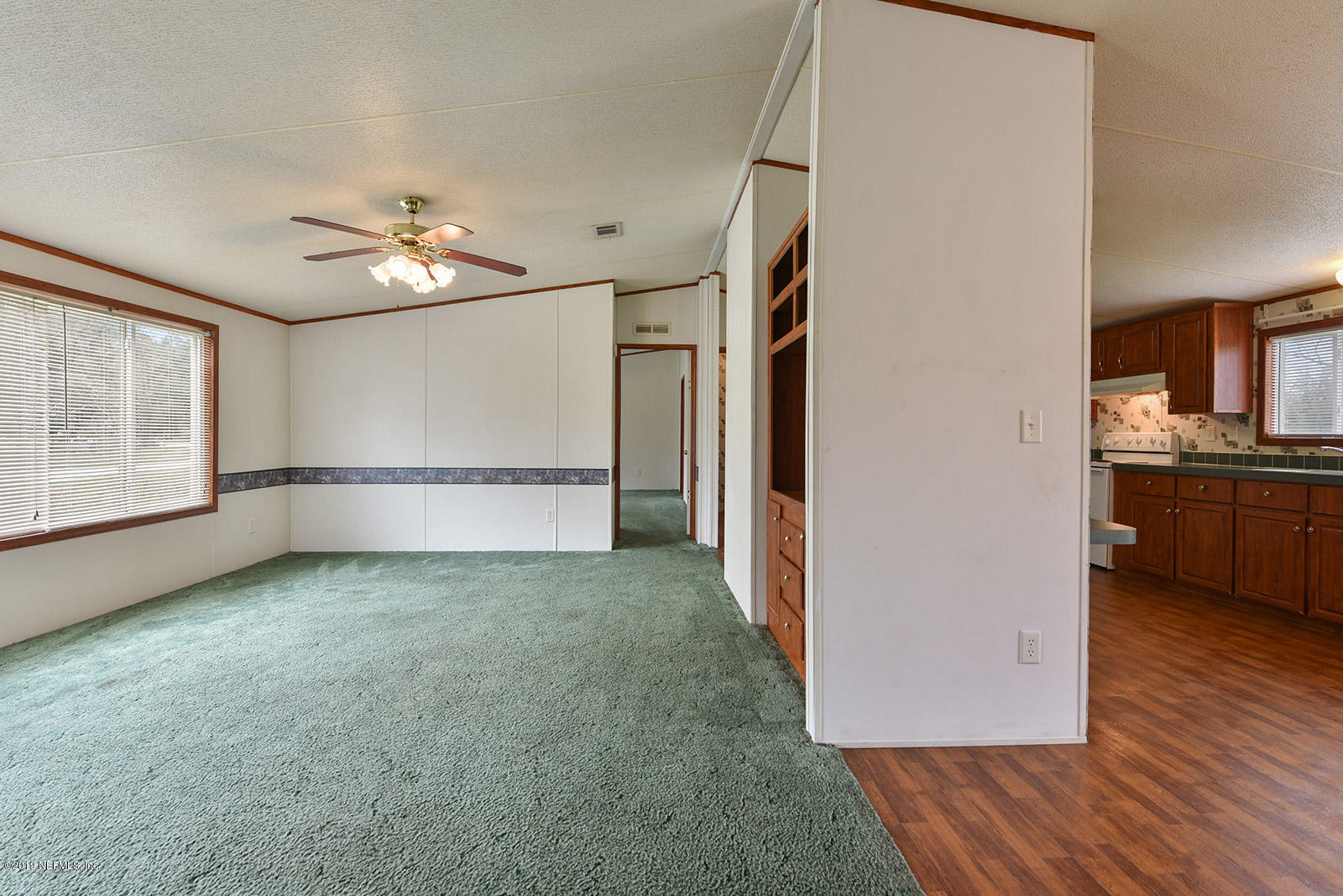 75302 Edwards Road Yulee, FL 32097 - Photo 7 of 25 a view of a kitchen with wooden floor and a kitchen