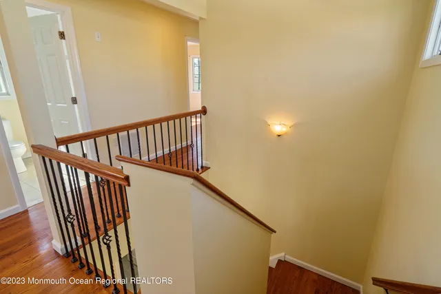 a view of a hallway with wooden floor and entryway