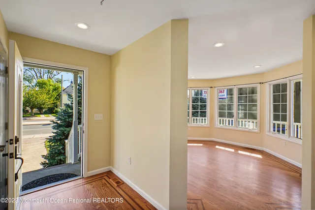 a view of an entryway with wooden floor and windows