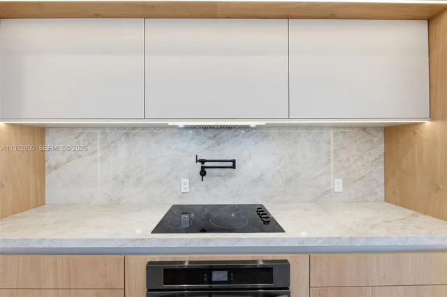 a bathroom with a granite countertop sink and a toilet