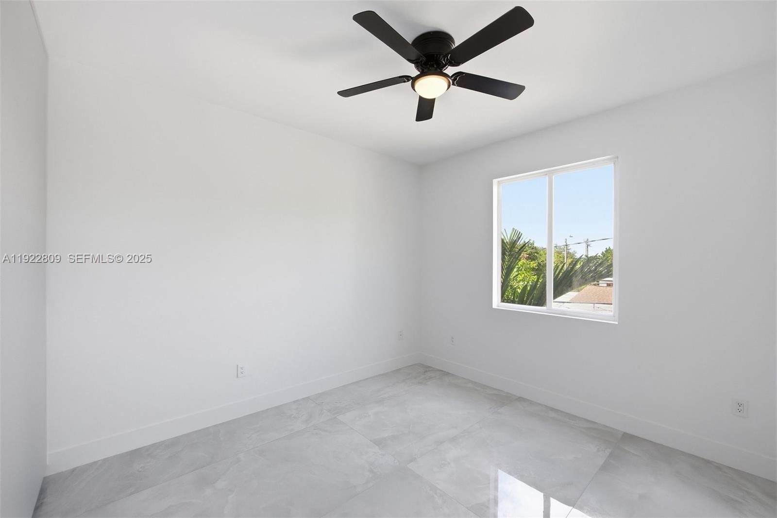 3111 Southwest 12th Street, Unit A Miami, FL 33135 - Photo 16 of 35 an empty room with window and ceiling fan