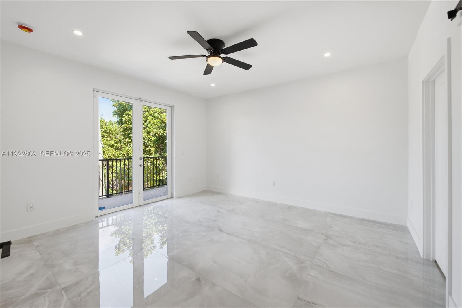 3111 Southwest 12th Street, Unit A Miami, FL 33135 - Photo 17 of 35 an empty room with ceiling fan and window