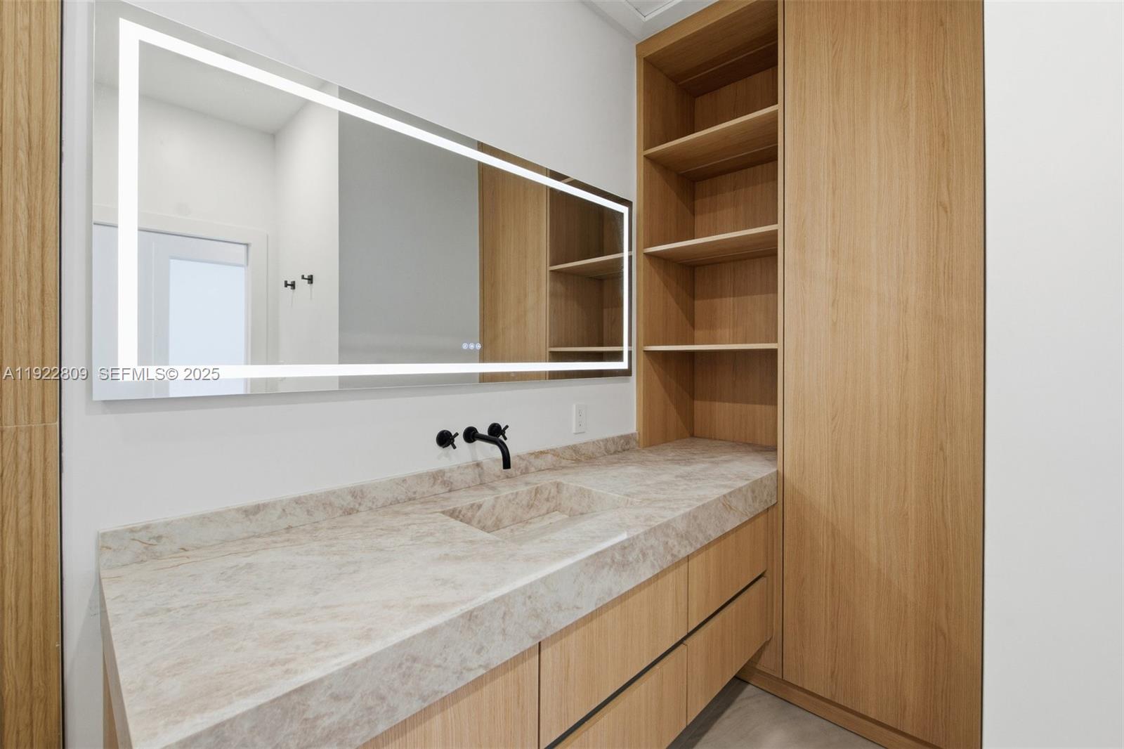 3111 Southwest 12th Street, Unit A Miami, FL 33135 - Photo 23 of 35 a bathroom with a sink and a mirror