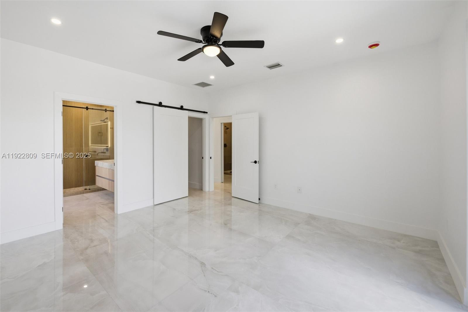 3111 Southwest 12th Street, Unit A Miami, FL 33135 - Photo 26 of 35 an empty room with closet and a ceiling fan
