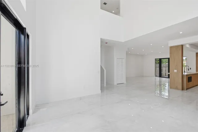 a large kitchen with stainless steel appliances granite countertop a large counter top a stove and a refrigerator