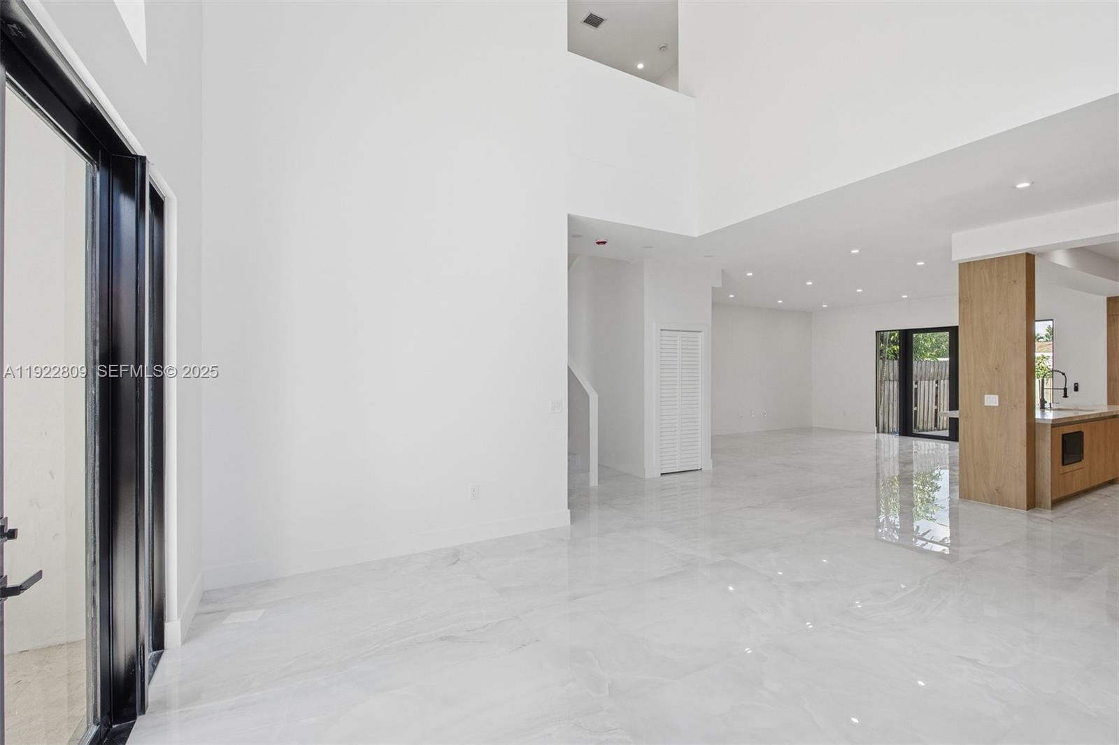 3111 Southwest 12th Street, Unit A Miami, FL 33135 - Photo 8 of 35 an empty room with a door