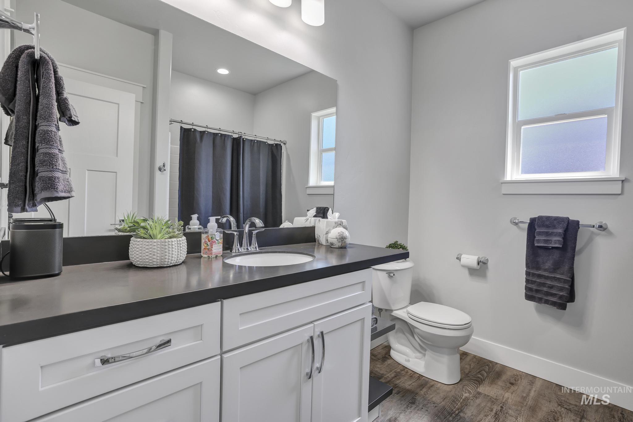 1937 Tamarack Loop Twin Falls, ID 83301 - Photo 26 of 50 Bathroom featuring a white vanity with recessed panel cabinetry, a dark countertop, an undermount sink, and chrome fixtures