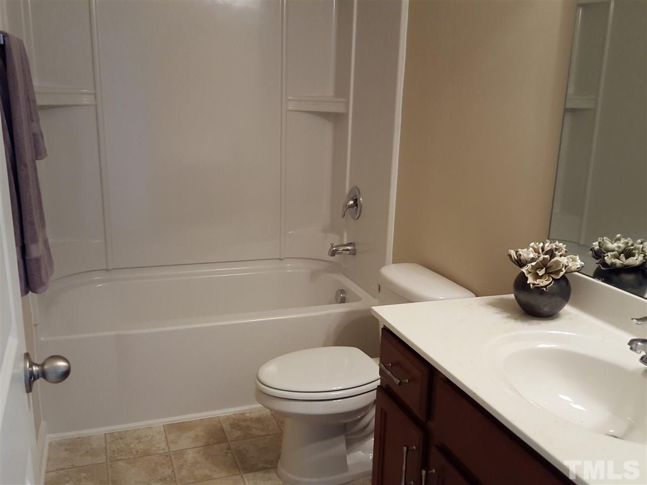 7613 Channery Way Raleigh, NC 27616 - Photo 16 of 25 a bathroom with a sink a toilet and shower