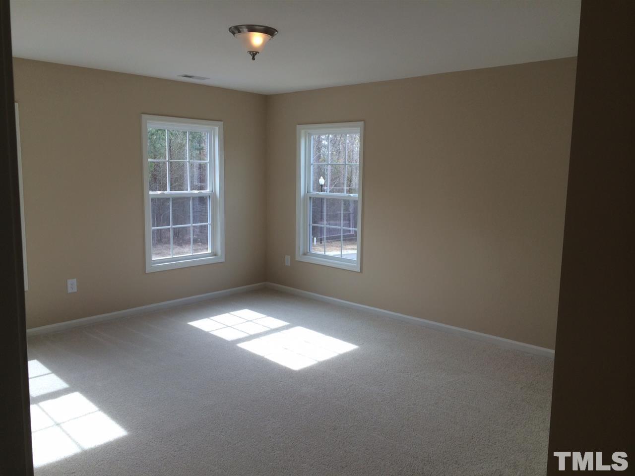 7613 Channery Way Raleigh, NC 27616 - Photo 17 of 25 an empty room with windows