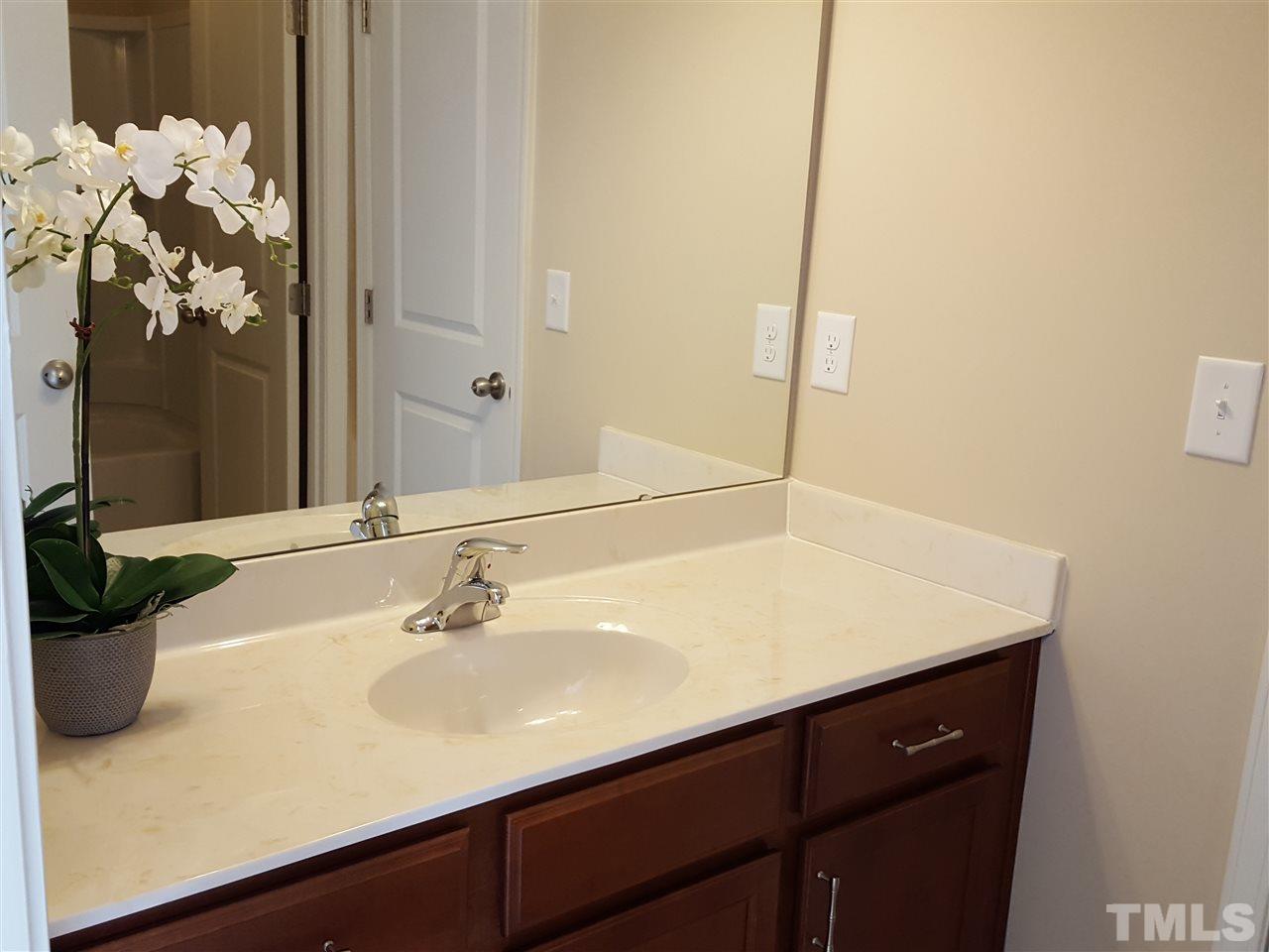 7613 Channery Way Raleigh, NC 27616 - Photo 18 of 25 a bathroom with a sink and a mirror