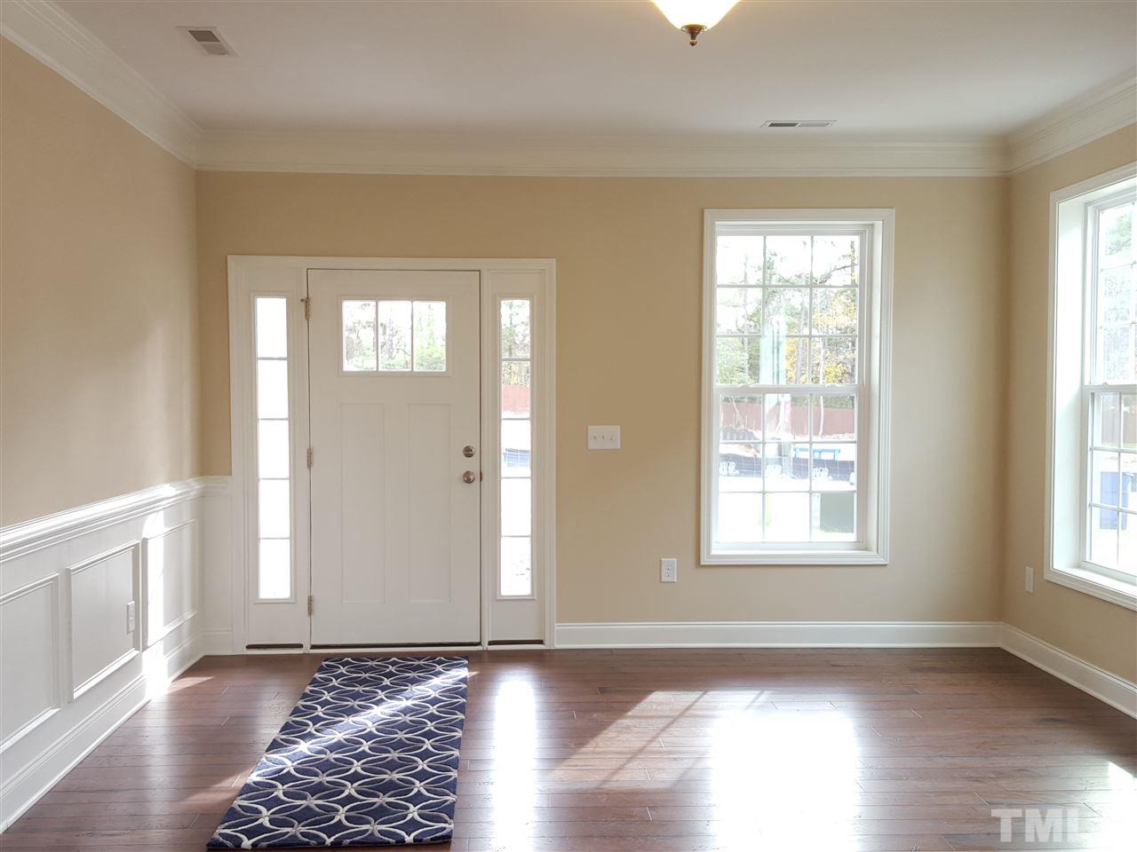 7613 Channery Way Raleigh, NC 27616 - Photo 3 of 25 a view of an empty room with wooden floor and a window