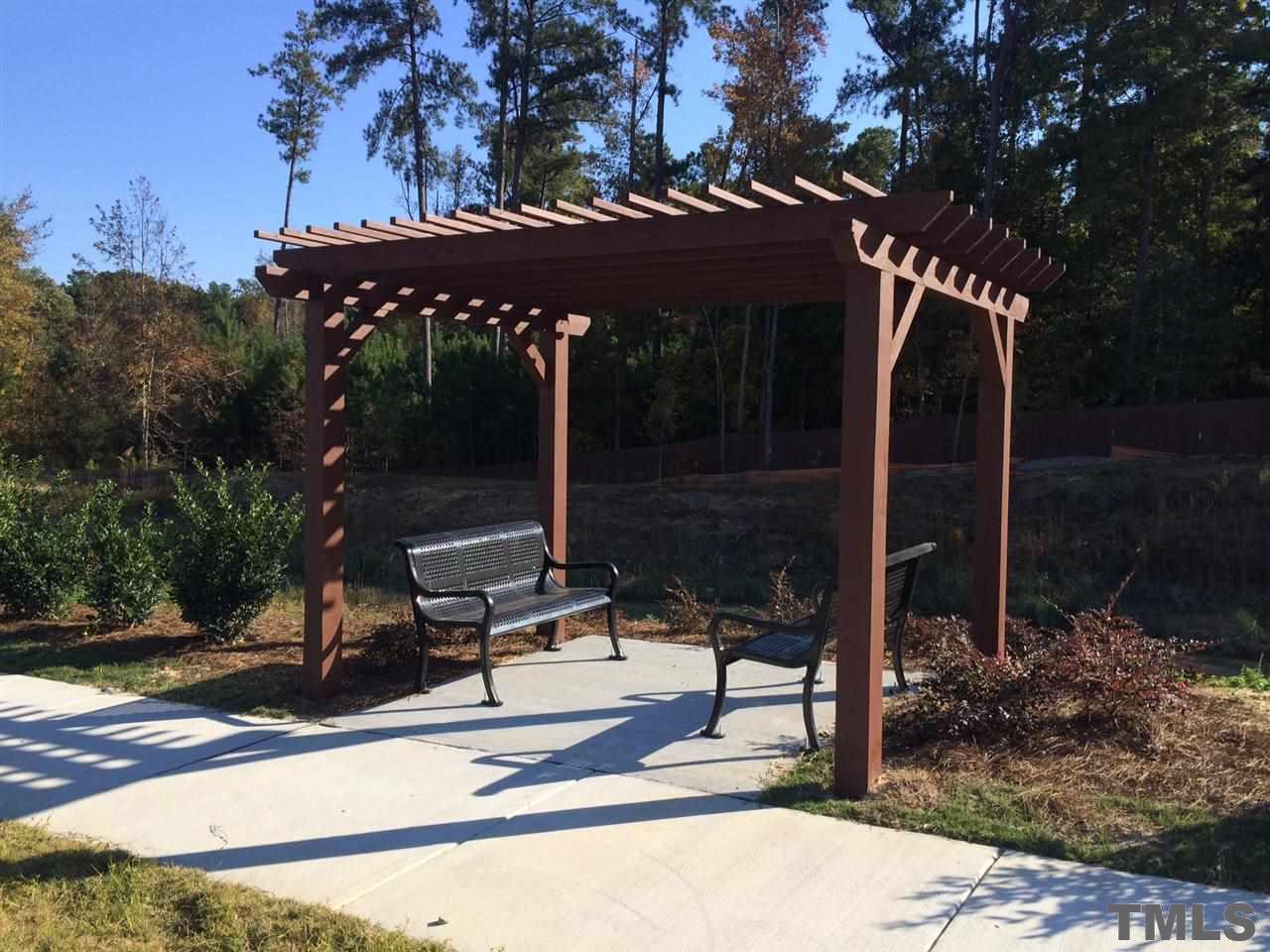 7613 Channery Way Raleigh, NC 27616 - Photo 22 of 25 a patio with table and chairs under an umbrella