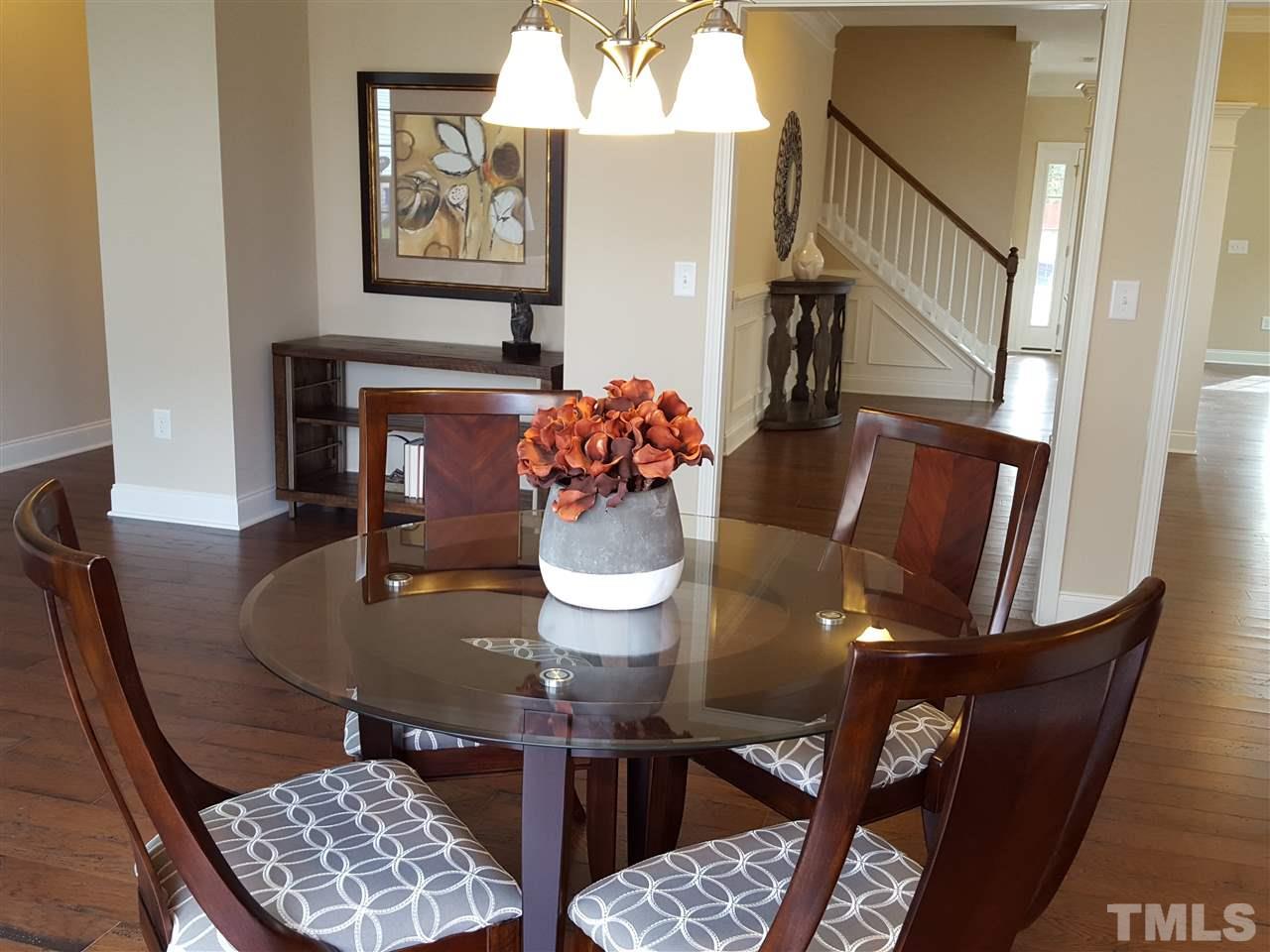 7613 Channery Way Raleigh, NC 27616 - Photo 7 of 25 a view of a dining room with furniture and wooden floor