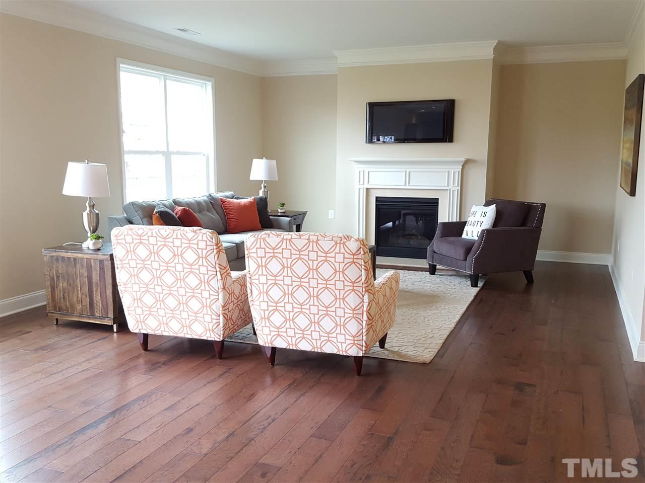 7613 Channery Way Raleigh, NC 27616 - Photo 8 of 25 a living room with furniture large window and a fireplace