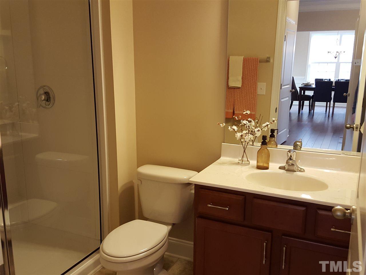 7613 Channery Way Raleigh, NC 27616 - Photo 9 of 25 a bathroom with a sink a toilet and shower