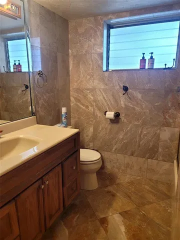 a bathroom with a sink a toilet and a mirror