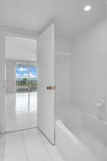 a view of a small space with wooden floor and a window