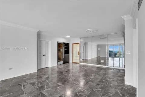 a kitchen with white cabinets and refrigerator