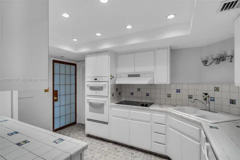 a kitchen that has a sink and a stove in it