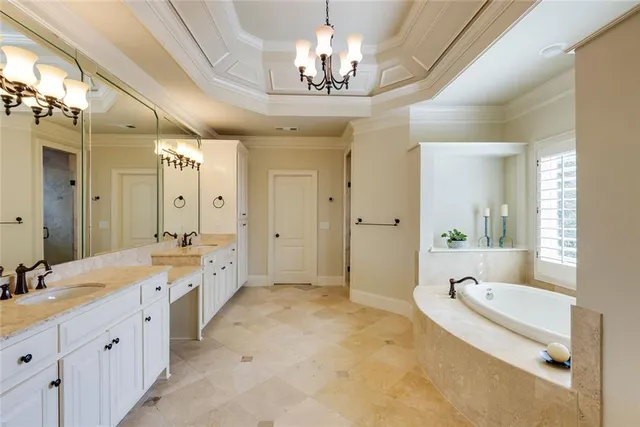 a spacious bathroom with a granite countertop tub sink a mirror a shower and a bathtub