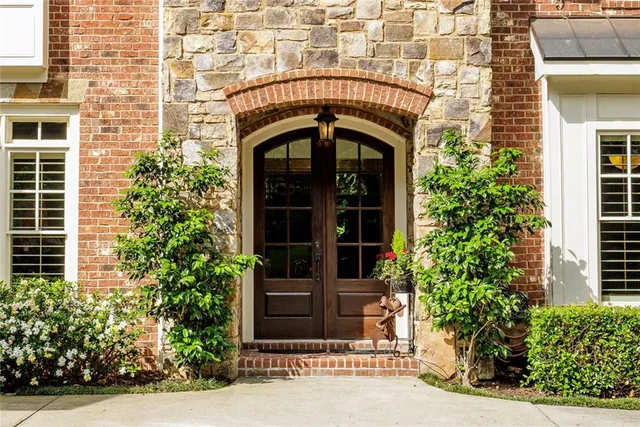 a front view of a building with a garden