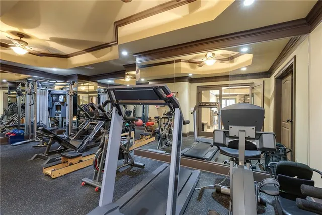 a bedroom with a bed a ceiling fan and a dresser