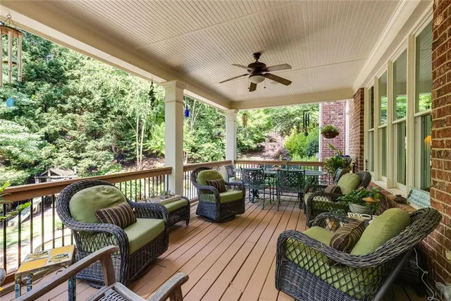 a view of swimming pool with lawn chairs and plants