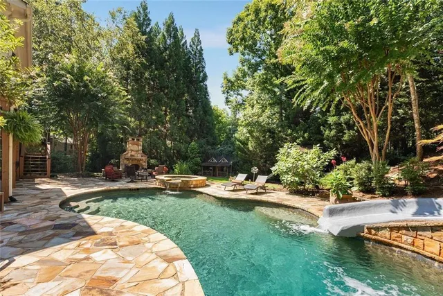 a view of a house with backyard porch and sitting area