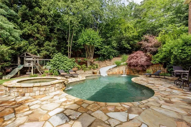 a view of a swimming pool with a patio