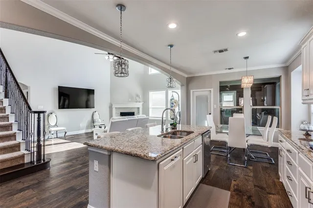 a kitchen with stainless steel appliances granite countertop a sink and stove
