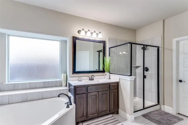 a bathroom with a tub a sink and a mirror