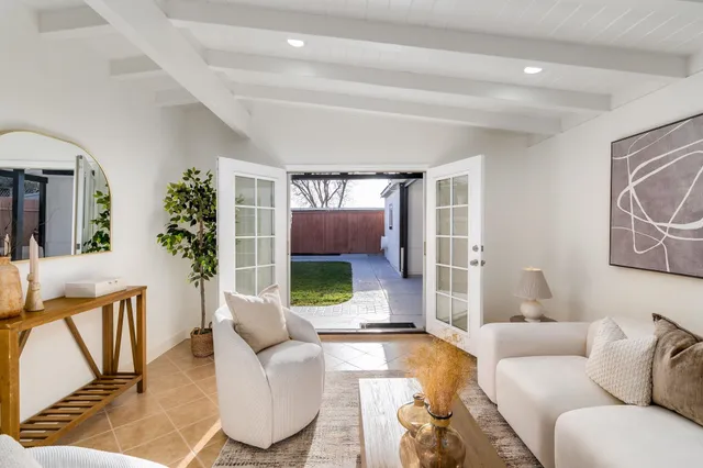 a living room with furniture potted plant and windows