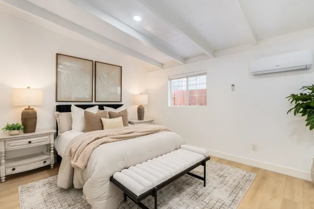 a bedroom with a bed and glass window