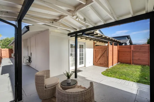 a view of a backyard with a tree