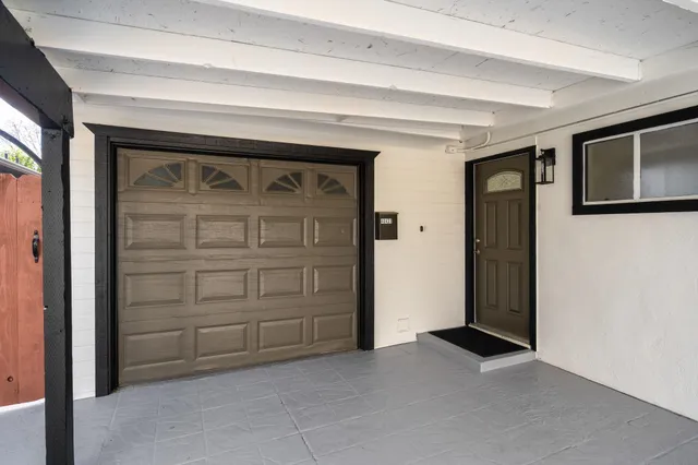 a kitchen with refrigerator a sink and white cabinets