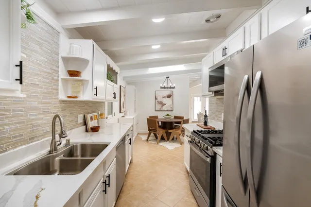a kitchen with sink cabinets and stove