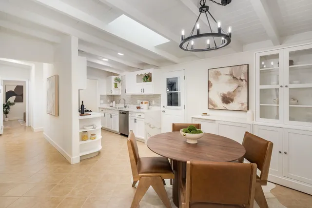 a dining room with furniture a rug and a chandelier