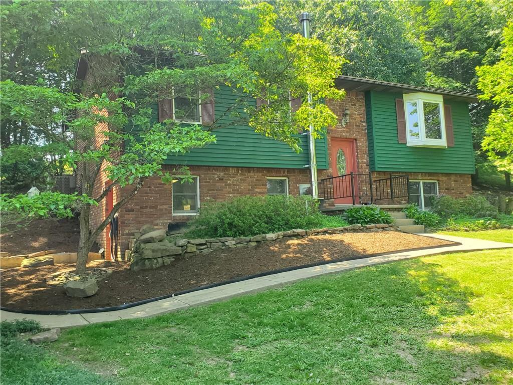 132 Hi Acres Road Greensburg, PA 15601 - Photo 36 of 45 a view of a yard in front of a house with plants and large tree