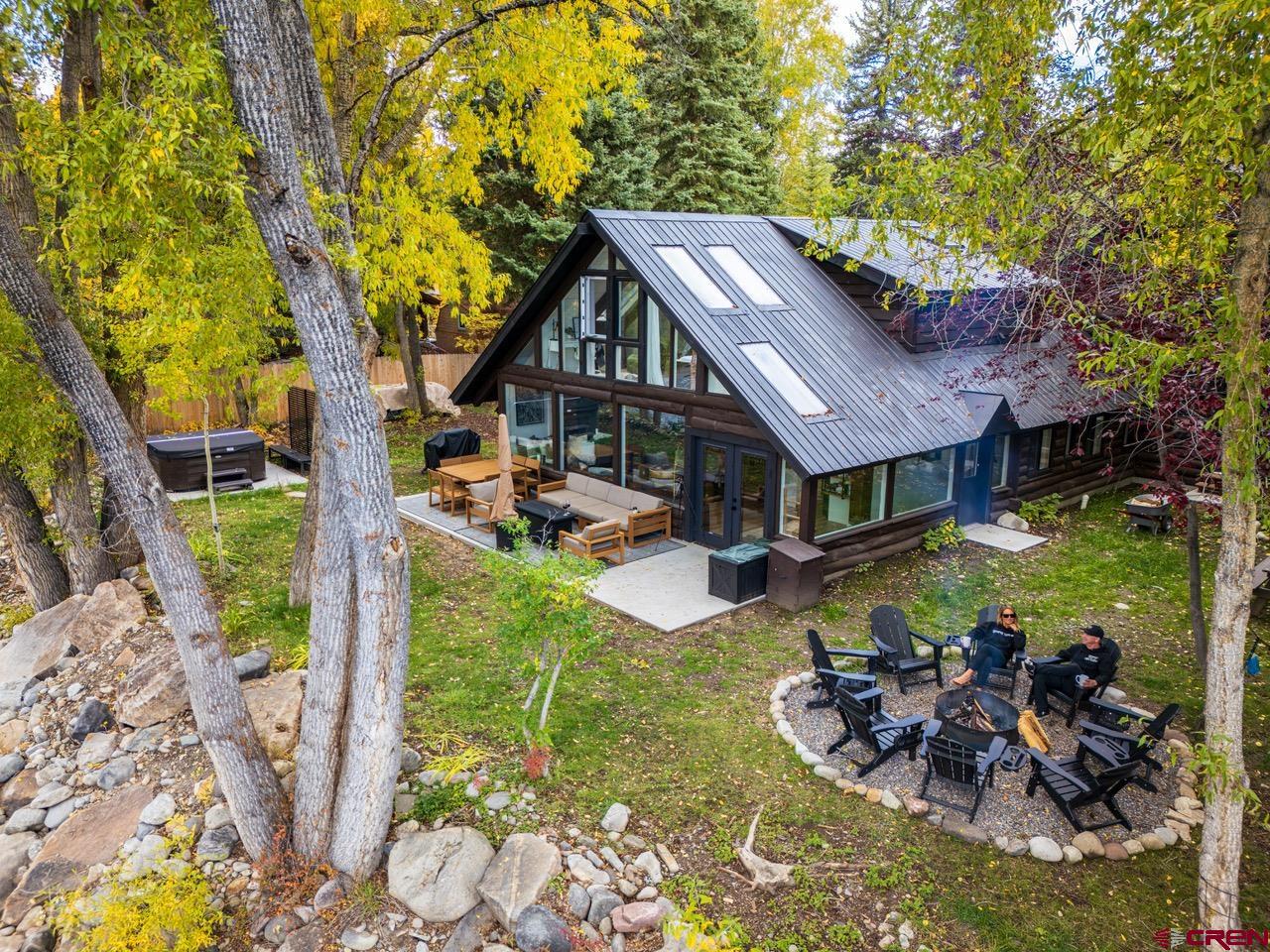 a view of a house with backyard porch and sitting area