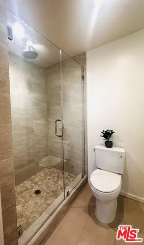 a bathroom with a toilet and a shower