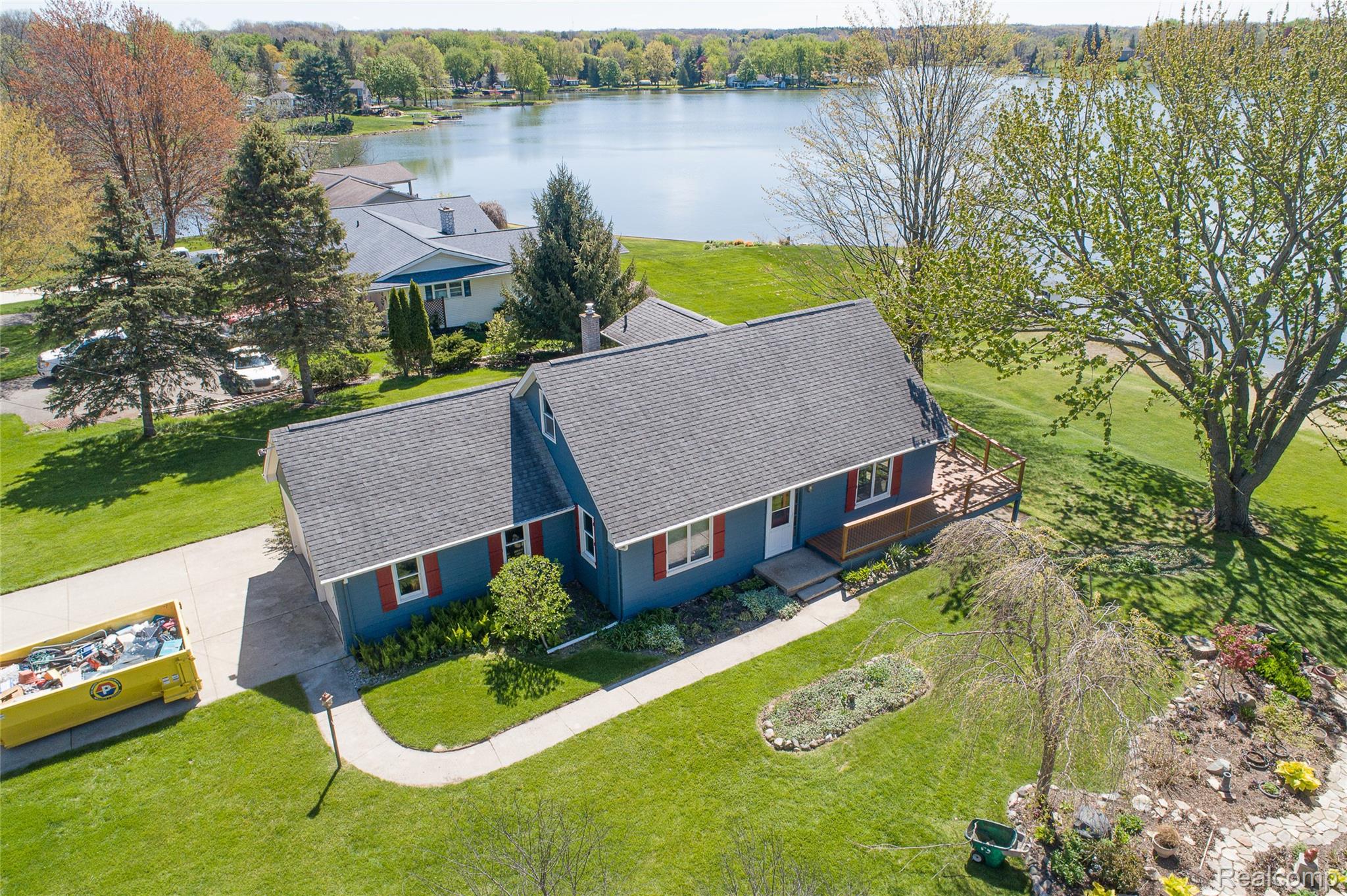 2855 Farmers Creek Road Metamora, MI 48455 - Photo 42 of 51 Waterfront property featuring a blue exterior, dark gray roof, and red window shutters