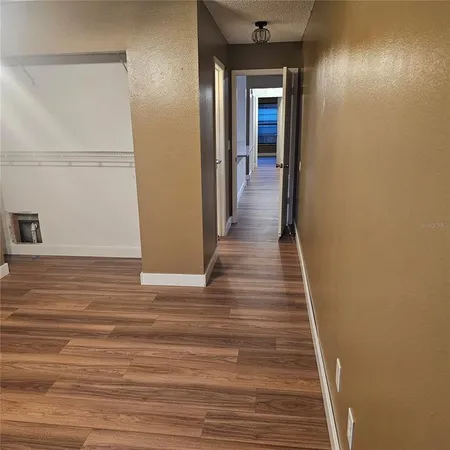 a kitchen with wooden floor and a sink
