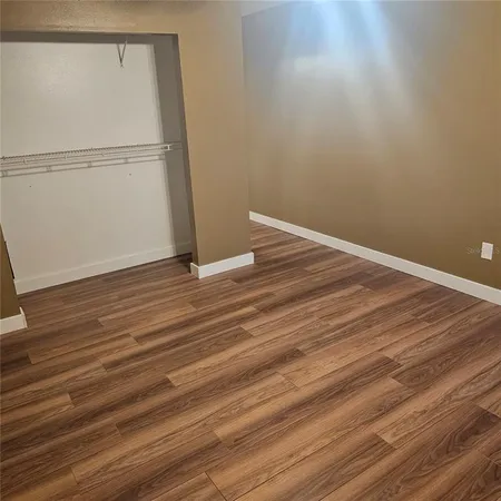 a view of a room with wooden floor