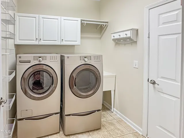 a view of a hallway with washer and dryer