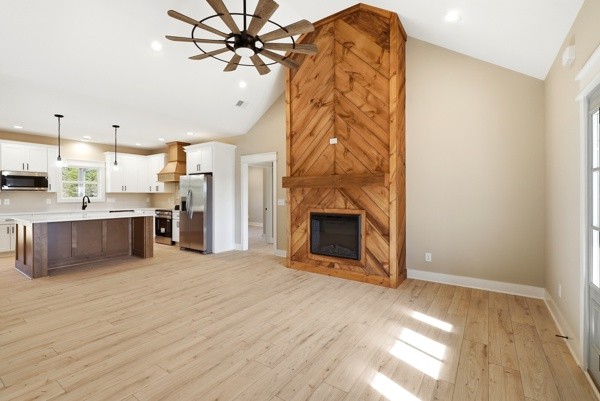 1180 Belfast Farmington Road Lewisburg, TN 37091 - Photo 12 of 41 a view of a kitchen with a sink and a fireplace