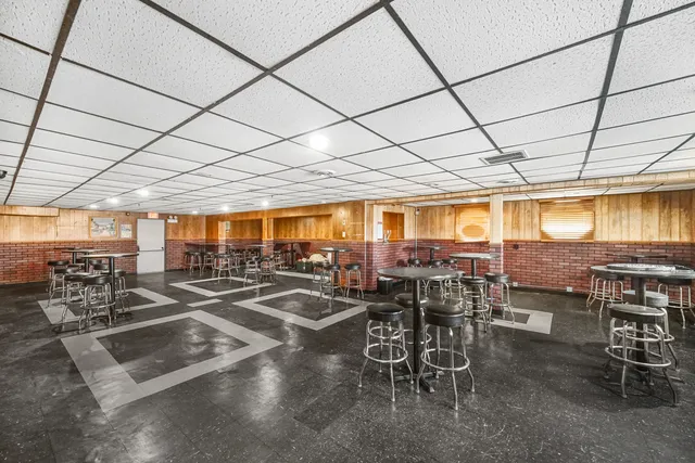 a room with lots of furniture and lots of windows