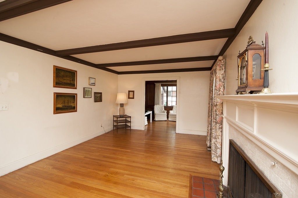 3 Rangeley Road Newton, MA 02465 - Photo 4 of 20 a view of empty room with wooden floor and fireplace