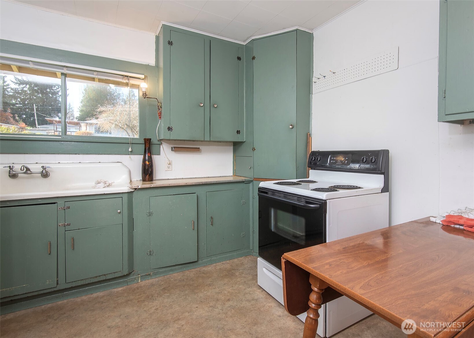 705 South 208th Street Des Moines, WA 98198 - Photo 16 of 20 a kitchen that has a sink and a stove