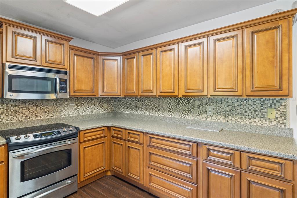 5031 Lakewood Road Sebring, FL 33875 - Photo 16 of 77 a kitchen with granite countertop cabinets stainless steel appliances and a sink